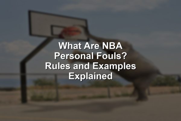 An NBA player gets whistled for a personal foul attempting to stop a layup, illustrating what are NBA personal fouls.