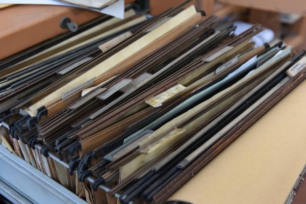 Illustration of how new Tesla insurance rates are set in 2025 with a Tesla and digital charts